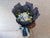 Bouquet of flowers wrapped in black paper with a blue ribbon 