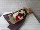 pure seed bq455 red & white roses & baby's breath in brown wrappers