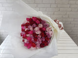 pure seed bq637 pink, purple & red roses hand bouquet in white wrappers