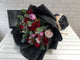 pure seed bq638 red, purple & pink roses + red berries + eucalyptus leaves hand bouquet in black wrappers