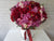 pure seed bk818 red & pink hued peonies + roses + eustomas + caspia flower arrangement