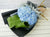 pure seed bq446 blue hydrangeas & silver leaves hand bouquet in black wrapper