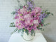 pure seed bk763 light pink & purple hued matthiolas + hydrangeas + roses + eustomas table flower arrangement