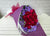 pure seed bq454 red roses & purple statice flowers hand bouquet in purple wrapper