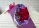 pure seed bq454 red roses & purple statice flowers hand bouquet in purple wrapper